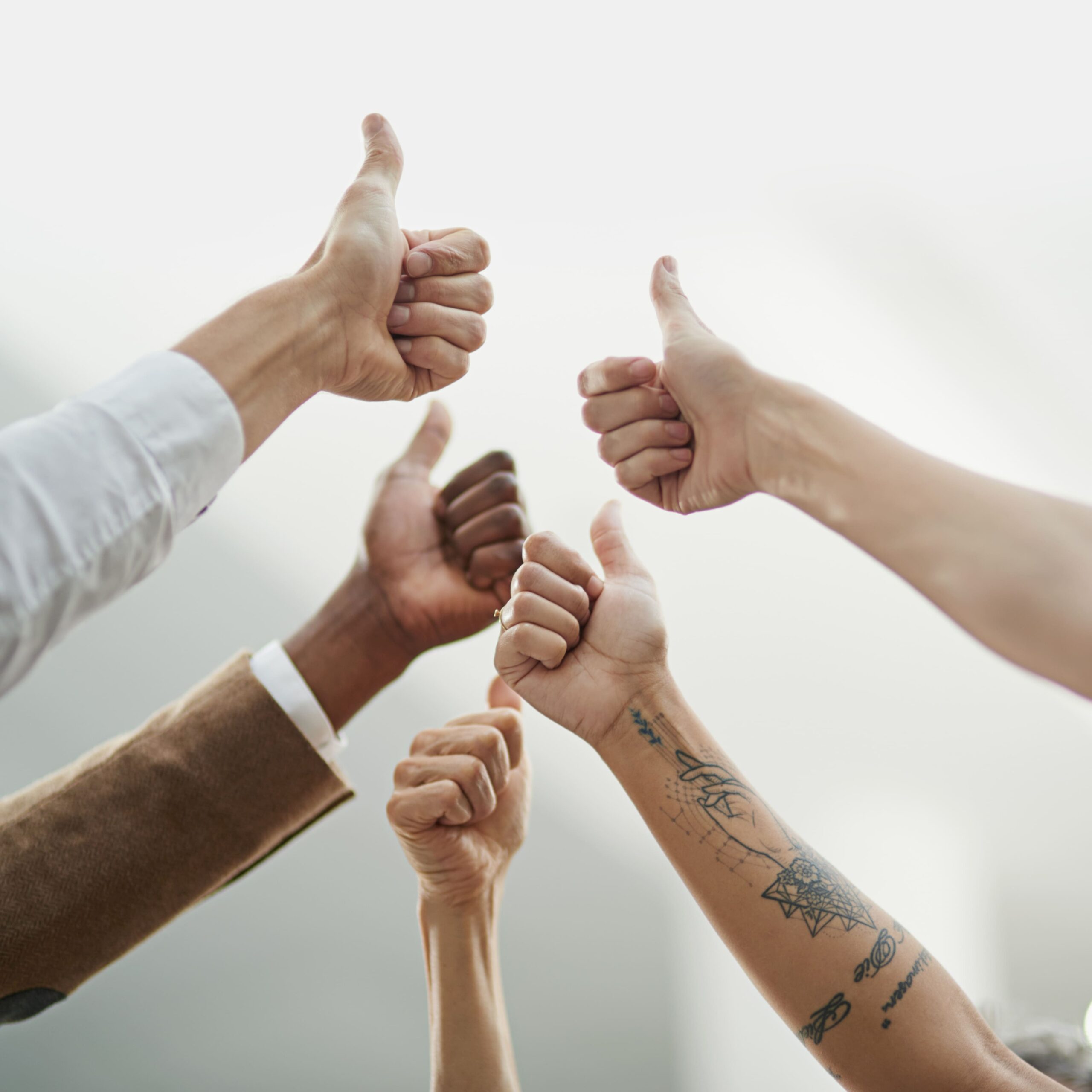 thats-affirmative-cropped-shot-diverse-group-unidentifiable-businesspeople-giving-thumbs-up
